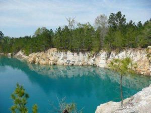 Water pooling between limestone cliffs with trees