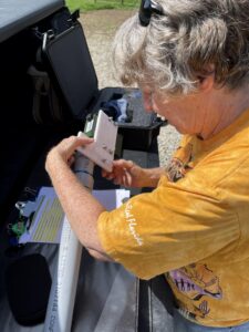 Acoustic Monitor Bat Detector being attached to pole by Bois d'Arc Texas Master Naturalist for deployment week 5