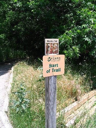 sign with text next to trail