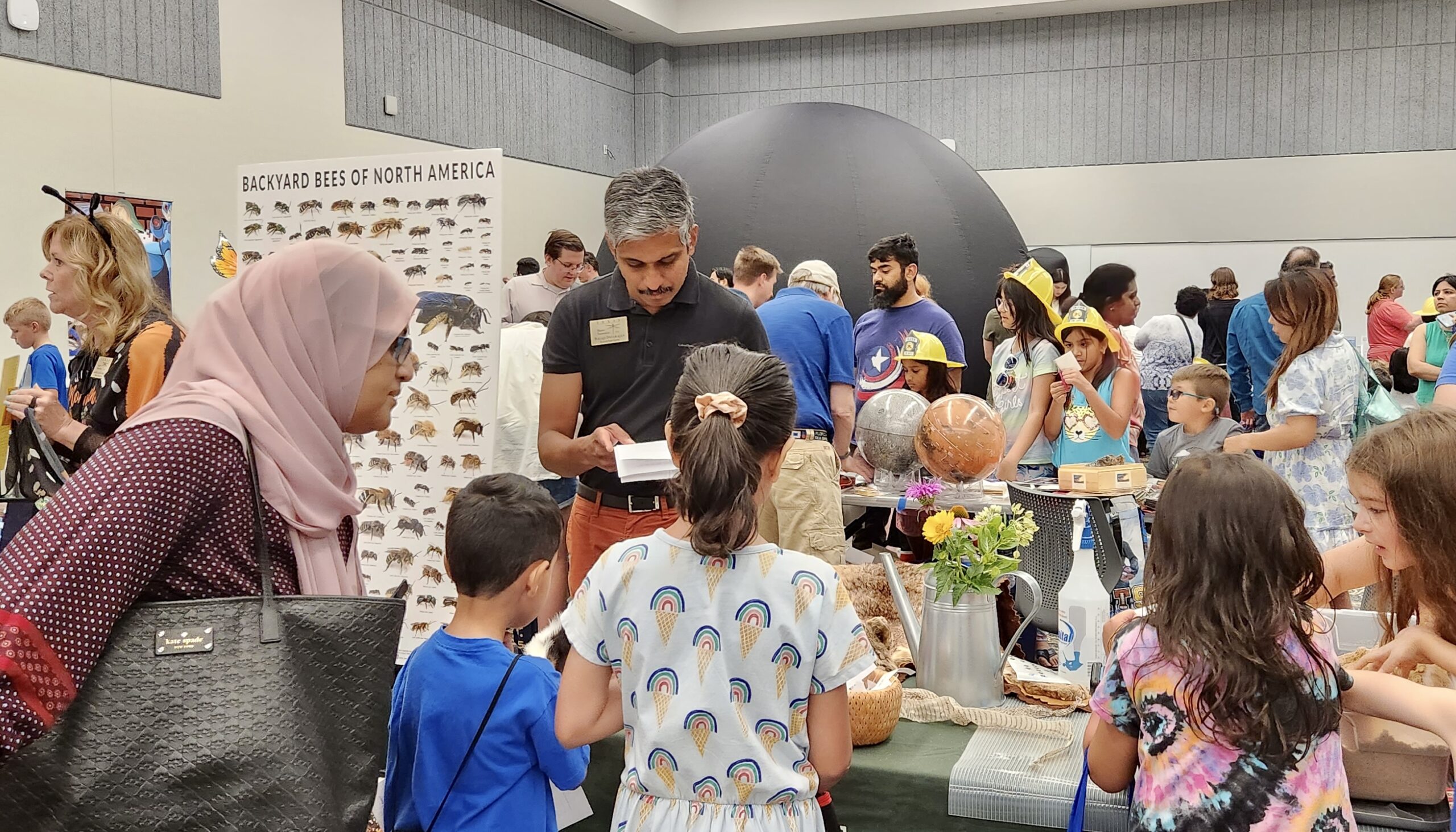 Balaji Devarajan engaging with the students at the Community Outreach Booth for Frisco Science Night 2023.