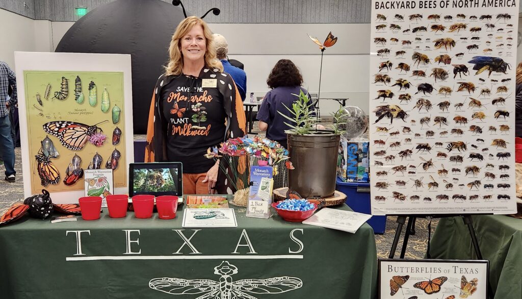 Cheryl Lynn Dillon in her Monarch Costume standing at the Community Outreach Booth for Frisco Science Night 2023.