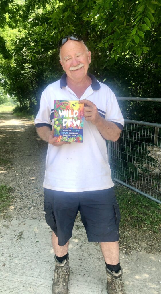 Bob Mione holding up a book at the Connemara Preserve