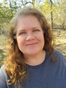 2023 07 July Deep Dive Speaker Kimberlie Sasan smiling in front of trees. 