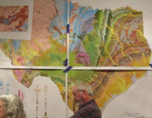 Lecturer in front of Texas map with geologic features