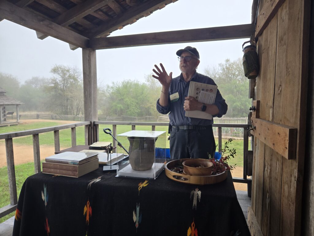 December 2025, Project leader Frank Michel talks to students about the naturalists of Texas while standing on the porch of the historical reconstruction of the town's hotel. Photograph by Krystyna Westfield