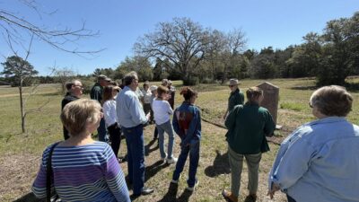 People taking a tour of the herbarium at Winedale