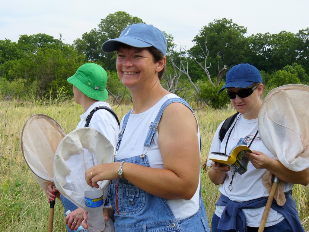 Chapter members smiling for the camera while also looking for butterflies.