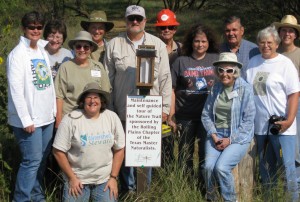 Work crew with new sign at the Trail Head