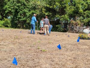 Volunteers planning the layout of a pollinator garden in an open field at the Big Thicket FRSLC in Saratoga.